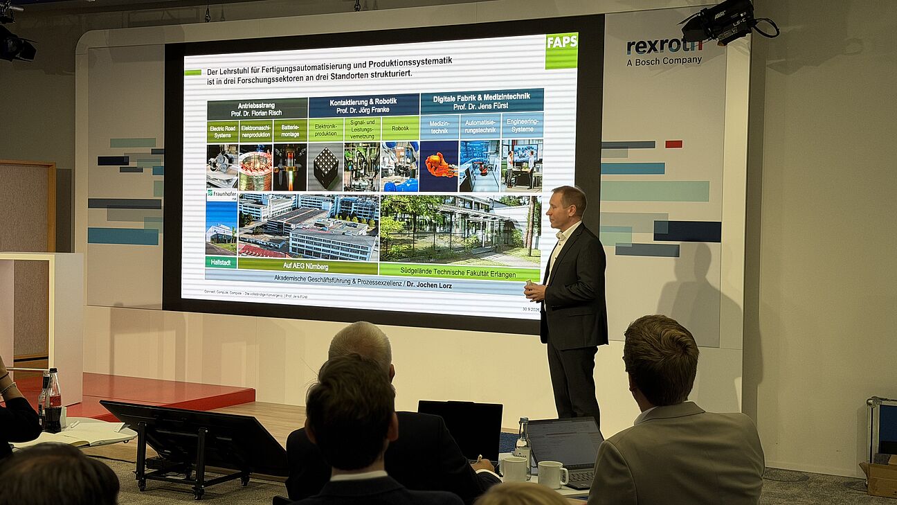 Automation Next Conference 2026 - Jens Fürst steht auf der Bühne und spricht zum Publikum